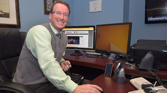 Jake Brown is pictured in his downtown Muncie office. Photo by Mike Rhodes