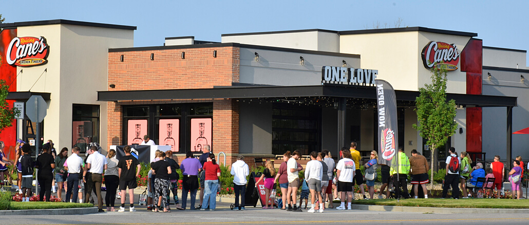 Patrons excited for the opening of Raising Cane's gather at 9am on opening day. Photo by Mike Rhodes